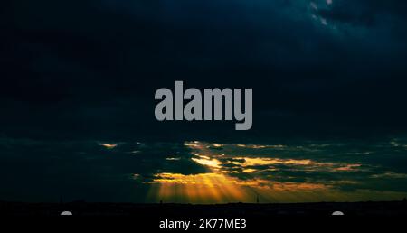 Panorama of a beautiful stormy sunset over the city in dramatic colors Stock Photo