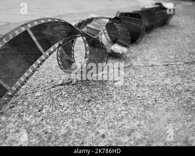 Unrolled old photographic film on the ground Stock Photo