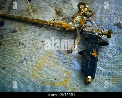 Old broken and clogged foam gun Stock Photo