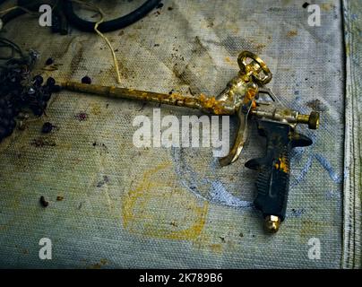 Old broken and clogged foam gun Stock Photo