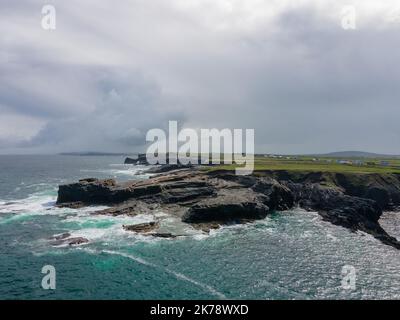 Ireland, County Clare - Bridges of Ross were three natural rock bridges, nowadays there is just one. Drone shot, areal view. Wild Atlantic Way. Stock Photo