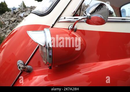 Detail of a small red vintage car with headlight and sideview mirror Stock Photo