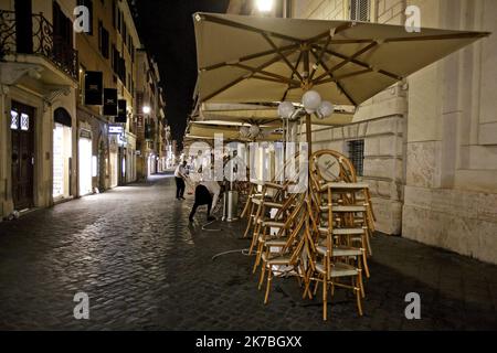 Stacked chairs are seen outside a coffee bar in Via Frattina, before a curfew imposed by the region of Lazio from midnight to 5 a.m to curb the COVID-19 infection, caused by the novel coronavirus. Rome, Italy, 24 October 2020 Stock Photo
