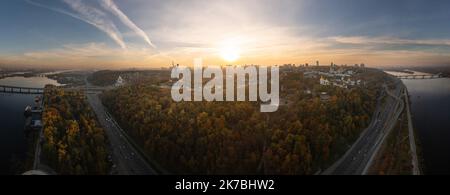 Kyiv, Ukraine - 15 October 2018: Aerial panoramic view of city at sunsety. Motherland statue close to center of picture. Stock Photo