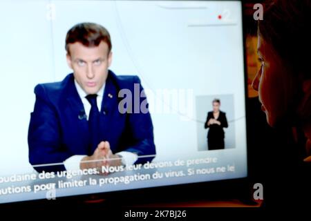 ©Pierre Teyssot/MAXPPP ; Coronavirus Pandemic - French President Emmanuel Macron address in Paris, France on October 28, 2020. In France a new Confinement will will start on friday. A new sweeping lockdown is in place in most part of Europe to try to slow down the spread of coronavirus pandemic. A girl watch the TV Screen showing French President Emmanuel Macron address. Pierre Teyssot / Maxppp  Stock Photo