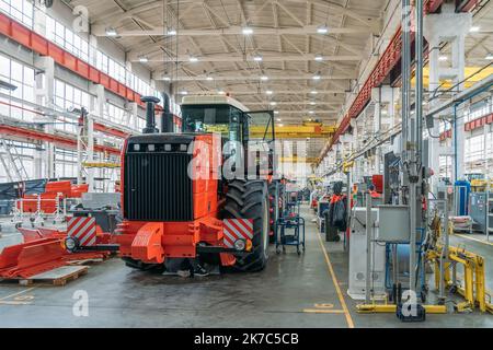 Conveyor line for assembly of tractors or combines at factory for the production of industrial agricultural machines. Stock Photo