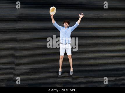 Young tourist man jumping for joy during vacation. Joy, vacation Stock Photo