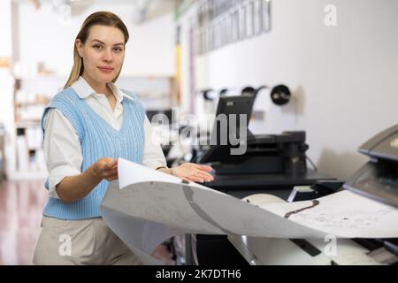 Worker in a printing and press centar check print quality Stock Photo