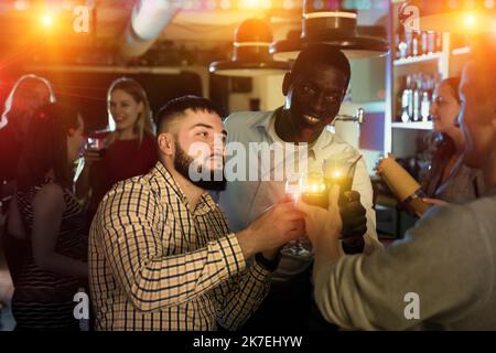Young people are resting on the corporate event in bar Stock Photo
