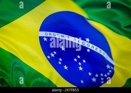 National flag of Brazil blowing on blue sky in Brasilia, South America Stock Photo