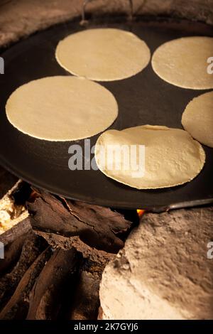 Tortilla baking on a camal skillet on the stove top. Stock Photo