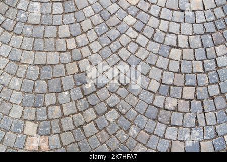 Old pavement of granite background. Top view on stone road close up. Stock Photo