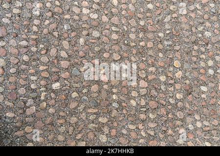 Old pavement of granite background. Top view on stone road close up. Stock Photo