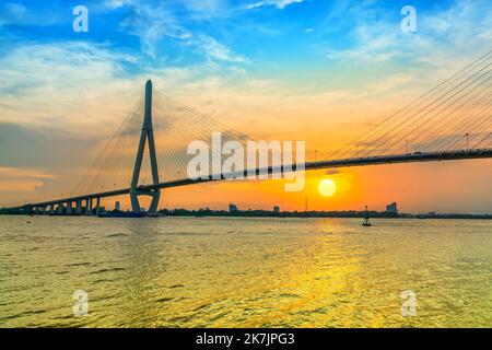 Sunset Can Tho bridge, Can Tho city, Vietnam. Cable-stayed bridge connecting road traffic in Vinh Long and Can Tho provinces for trade and commerce Stock Photo