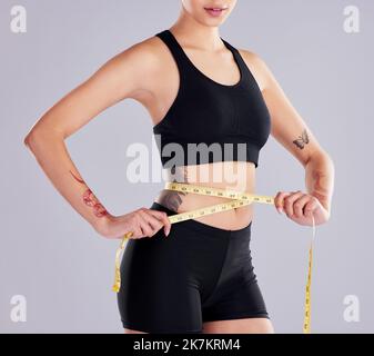 Sporty woman using waist tape line in fitness gym sport club training ...