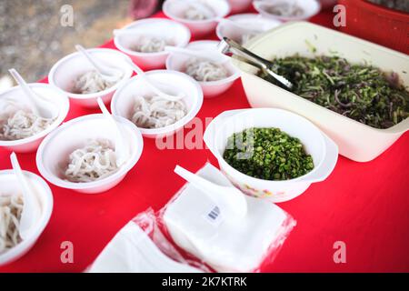 LAKSA. Made using rice and the sauce is made from kembang fish. Side dishes such as kesum leaves, onion, chili, boiled chicken egg and musk lime. Stock Photo