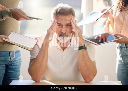 Stuck in a dance of collapsing walls. a mature businessman looking stressed and frustrated in a meeting at work. Stock Photo
