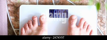 Man stands on scales on scales figure 80 kilograms Stock Photo