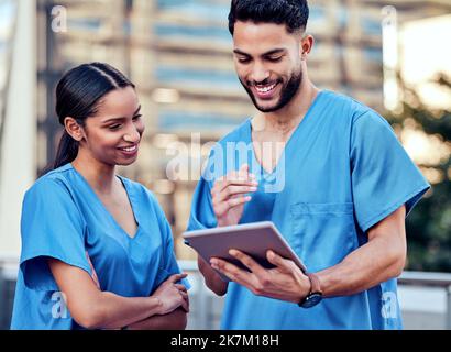 This video is funny. two young doctors using a digital tablet in the city. Stock Photo
