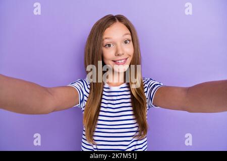 Photo of nice satisfied glad girl with straight hairdo dressed striped t-shirt doing selfie smiling isolated on purple color background Stock Photo