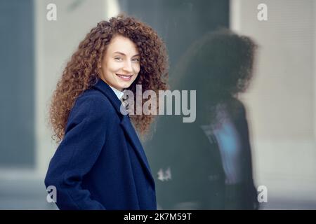 Happy smiling young woman on the street Stock Photo