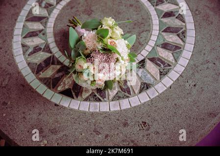 Wedding bouquet made of white roses wedding bouquet of the bride on the lawn or table Stock Photo