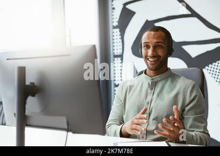Handsome african businessman working computer while sitting in modern coworking Stock Photo