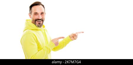 Man face portrait, banner with copy space. happy handsome mature man in hoody pointing finger on copy space isolated on white, presentation. Stock Photo