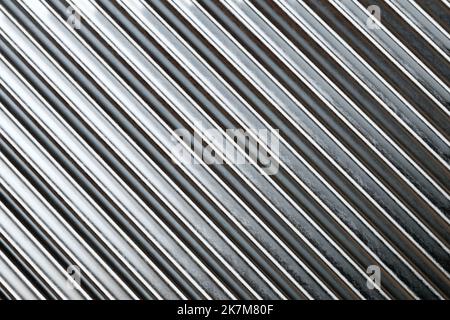 Texture of silver roof metal sheet. Metallic plate texture. Diagonal silver grey stripes wallpaper banner design. Corrugated metal plate background. Stock Photo