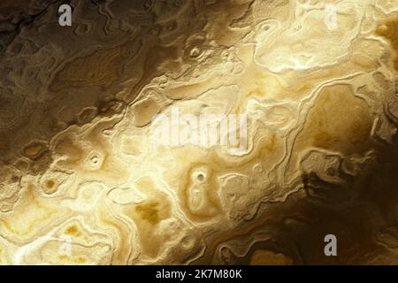 Abstract emotional art. Luxury gold metallic wall with wavy patterns, Golden liquid acrylic paints, abstract texture background. Stock Photo