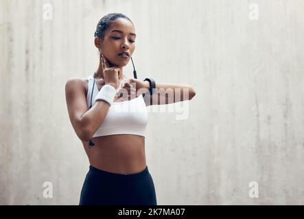 Smartwatch, fitness and thinking black woman check time running results or training workout progress on wall mock up marketing. Sports athlete with Stock Photo