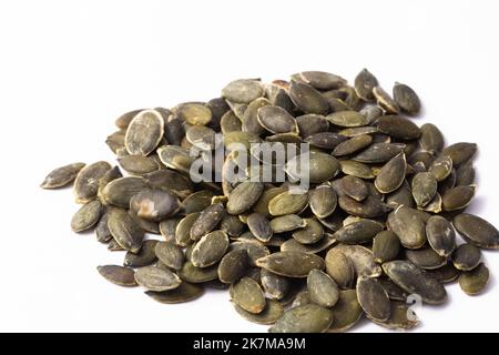 Hulled pumpkin seeds on white background Stock Photo