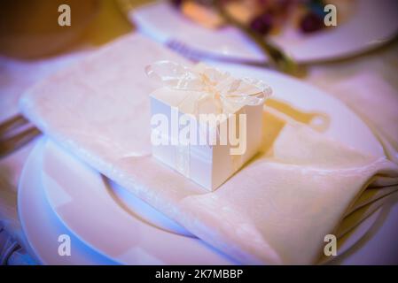 Decorated plate with fork and spoon. Table set up in boho style with pampas grass and greenery Stock Photo
