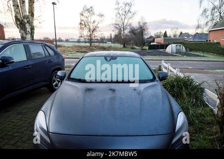 A portrait of a frozen windshield of a completely frozen car during winter. The ice first needs to melt or be removed before the driver can safely sta Stock Photo