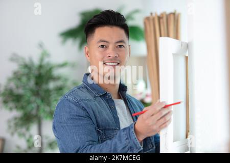 handsome young man installing bay window construction site Stock Photo