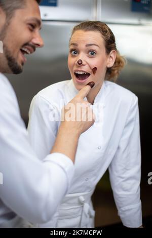 worker in chocolate factory having fun Stock Photo