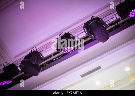 Light heads beam and fill hang on a truss above the ceiling in event hall Stock Photo