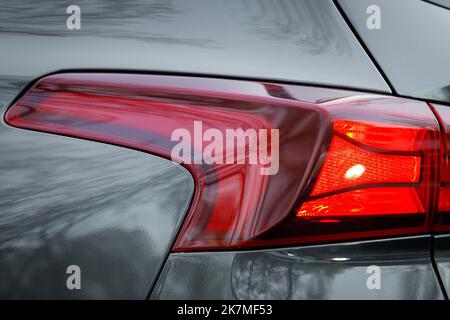Close-up on the taillight of a gray car Stock Photo