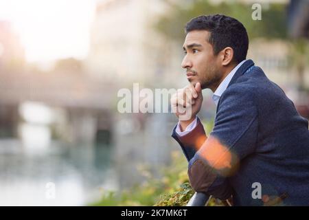 Thinking back to happier times. a young businessman lost in thought. Stock Photo
