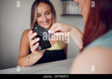 Hands, woman and credit card tap to pay on electronic machine for wireless transaction at cafe. Hand of female in contactless payment tapping on Stock Photo