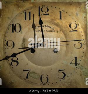 Close up photograph of an antique weathered clock face circa the British Raj in India,  with inscription 'P.Orr and Sons Ltd. Madras and Rangoon' Stock Photo