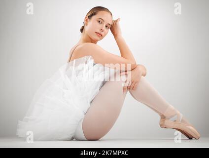Ballet is my passion. Full length portrait of an attractive young female ballet dancer in studio against a grey background. Stock Photo