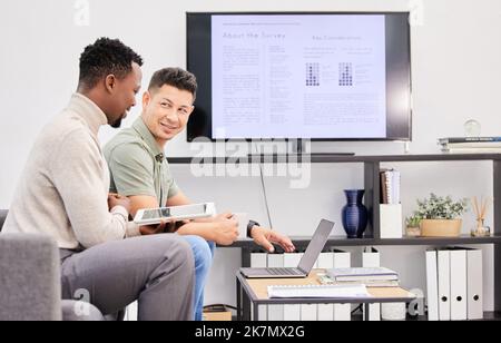They know what to do in order to succeed. two businessmen using a laptop and digital tablet together in an office. Stock Photo