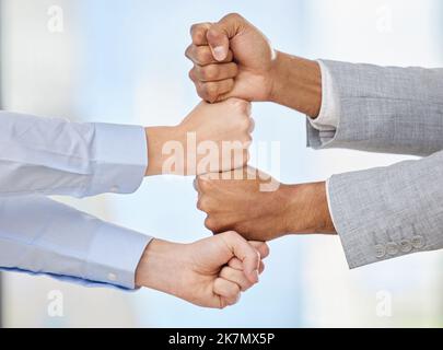 Our strengths combined lead to an unbreakable bond. two unrecognisable men stacking their fists together. Stock Photo