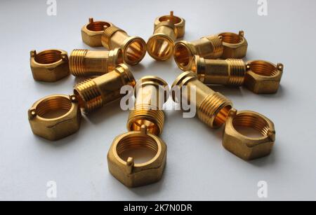 Male Brass Water Meter Fittings And Union Nuts Laid Out In The Form Of Flower On White Surface Stock Photo