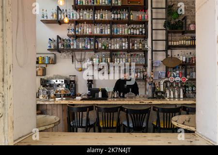 A man prepares to open a well-stocked bar in Tel Aviv Stock Photo