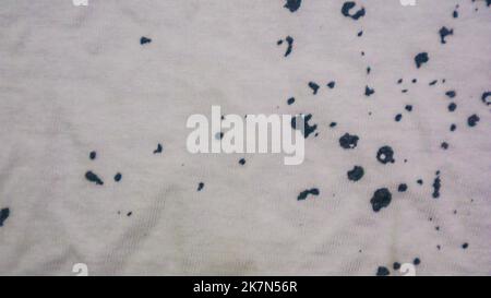 White cloth texture with black spots as background Stock Photo