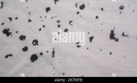 White cloth texture with black spots as background Stock Photo