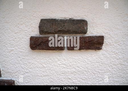 Stone wall with decorative stones and facings Stock Photo