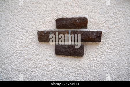 Stone wall with decorative stones and facings Stock Photo